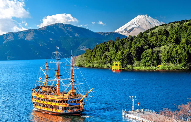 Hakone pirate ship cruising Lake Ashi with Mount Fuji behind on a fuji five lakes tour, Japan